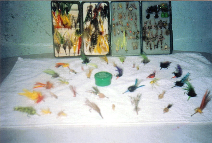 Open fly box and dozens of colorful saltwater flies laid out for bonefish, tarpon and permit fishing at Isla Blanca, Cancun