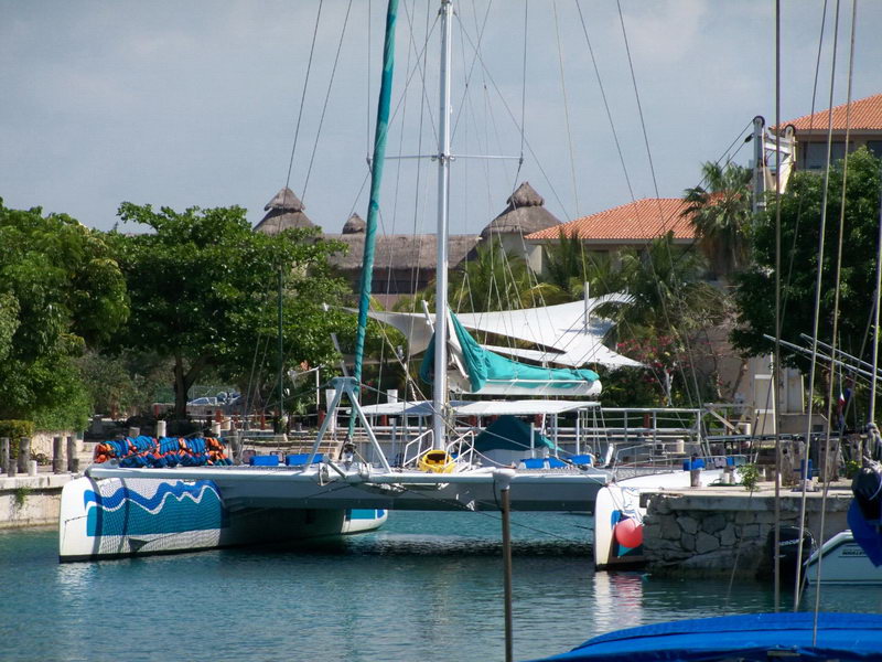 Cubierta del catamarán Raiatea llena de pasajeros durante tour grupal de navegación Puerto Aventuras Riviera Maya